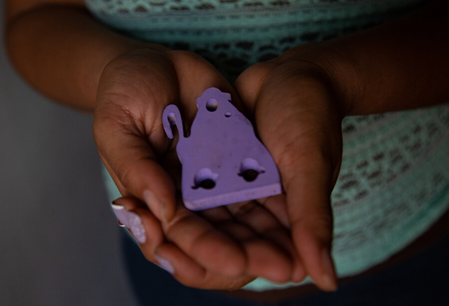 A small religious icon is cusped in a pair of hands